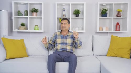 Old man dancing happily by himself at home.