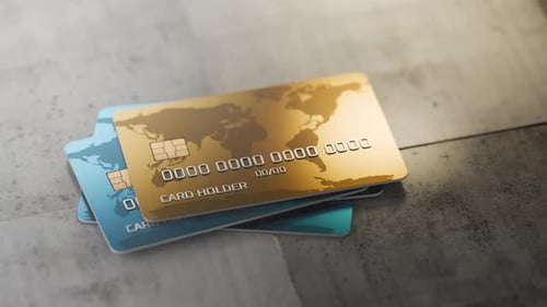 Rotating the camera around bank cards. Several bank cards are stacked on a concrete table.