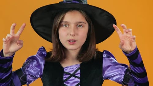 Girl in Witch Costume Doing Halloween Hand Gestures