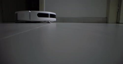 Autonomous Robot Vacuum Cleaning White Tiled Floor