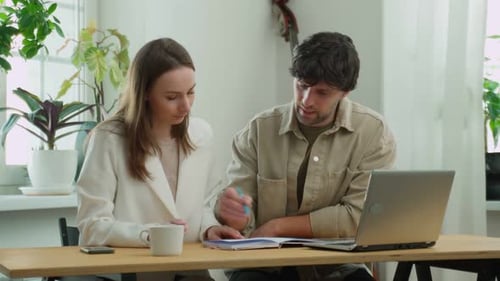 Two Young Business Colleagues are Working on a Computer Teamwork and Meetings at the Desk to Develop