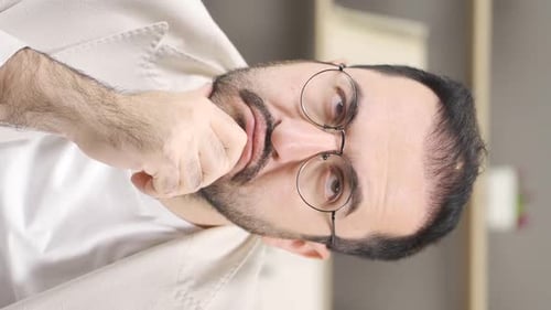 Man Ponders with Hand to Face Close Up