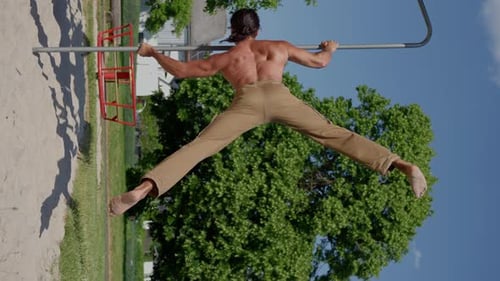 A Man with Perfect Body Trains with Effort and Determination Gymnastic Elements