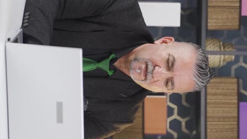 Man Working at a Laptop in Office Vertical