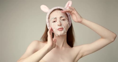 Woman Applies Hydrating Face Mask with Bunny Ears