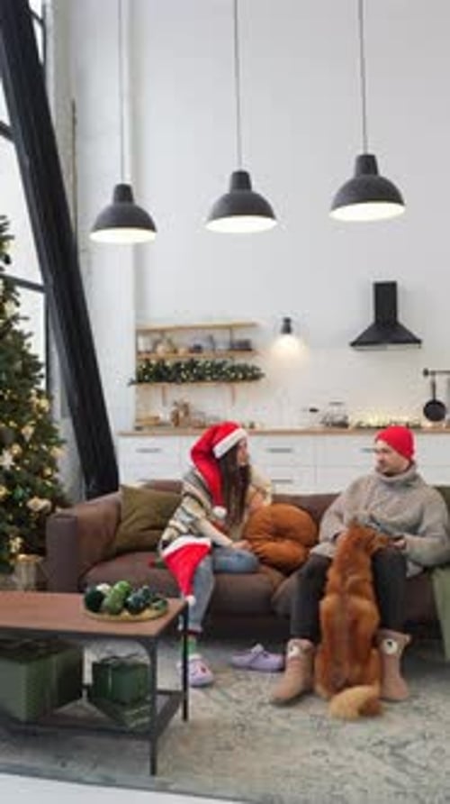 Couple with Dog Relaxing at Home for Christmas