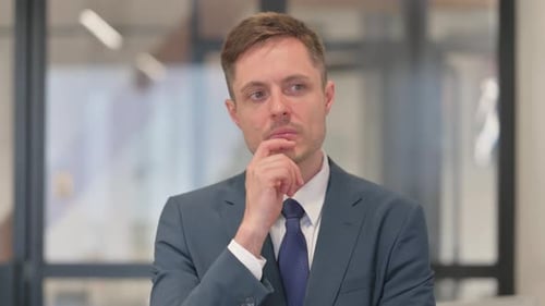 Thoughtful Businessman Contemplating Options in the Workplace