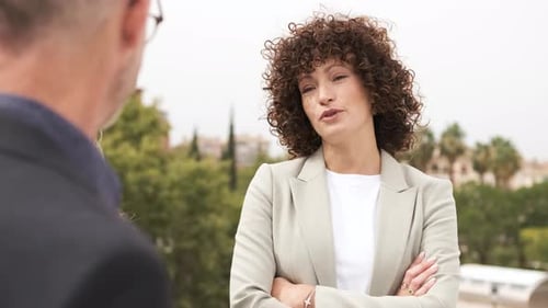 Happy Business People Discussing on Building Terrace in City