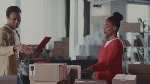 Couple Efficiently Preparing Online Orders Together Partners Carefully Packing Merchandise in Bright