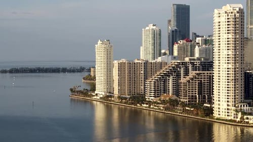 Downtown Miami Florida azure waters and white sand beach flyover by drone