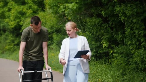 Healthcare Professional Assisting a Patient Outdoors in a Natural Green Setting