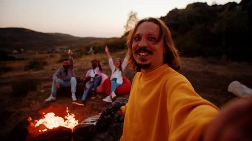 Friends Enjoy Campfire at Sunset with Selfie