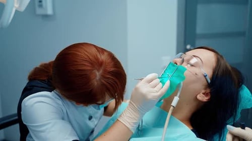 Dentist Performing Dental Procedure on Patient in Clinic