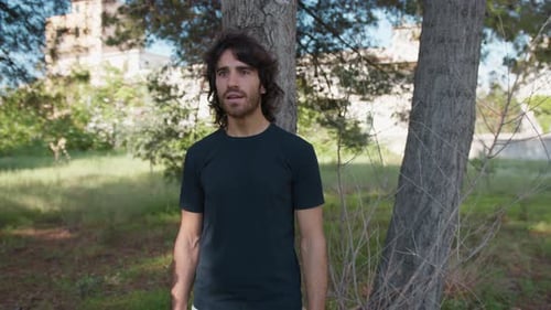 Young Long Hair Man Marveled In Nature Near A Tree