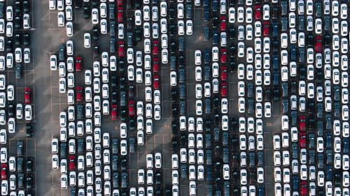 Top Down View of a Giant Parking Lot with New Cars