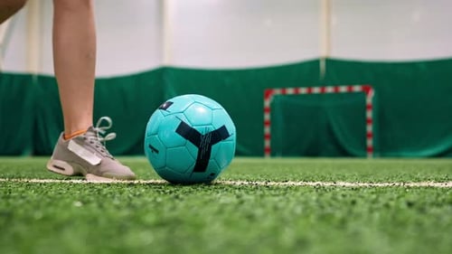 close-up of a soccer player's foot kicking the ball for a penalty or a goal or passing a ball