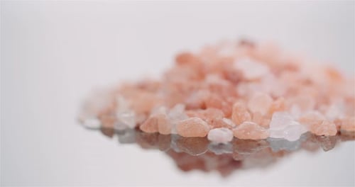 Pink Himalayan Salt Crystals Close-Up on Reflective Surface