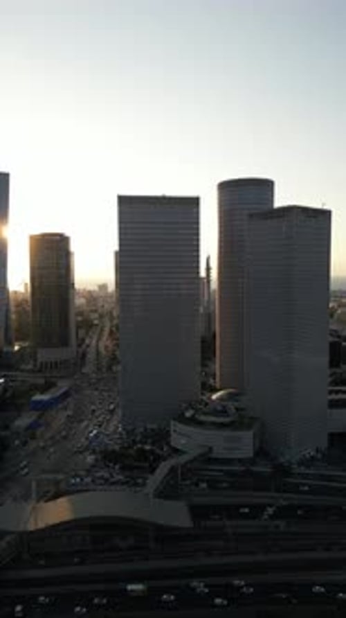 Aerial Shot Of Cityscape By Sea Against Sky At Sunset, Drone Descending Forward Over City - Tel Aviv