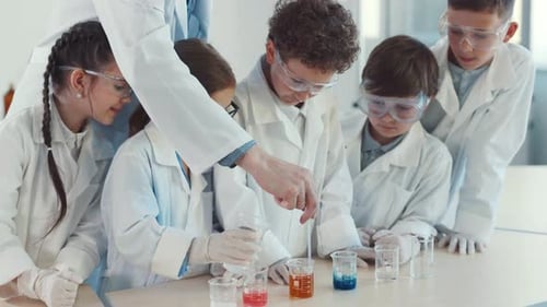 Excited Children Conduct a Science Experiment in a Lab
