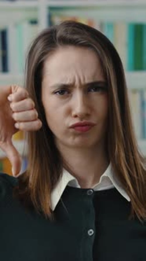A Young Woman in an Academic Setting Surrounded By Various Books and Educational Materials