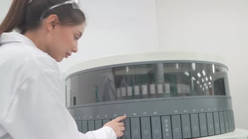 Young Woman Working with Medical Testing Equipment