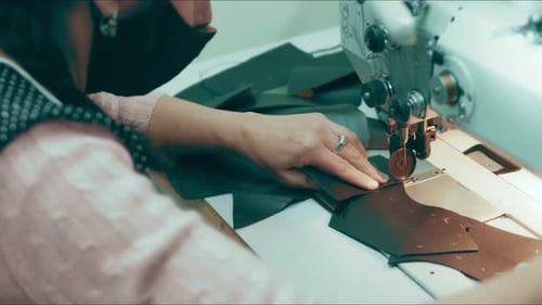 Sewing Machine in a Leather Workshop in Action with Hands Working on a Leather Details for Shoes