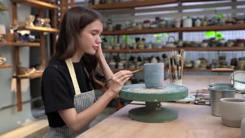People Creating Pottery in Studio. Female artisan creating handmade ceramics in pottery workshop