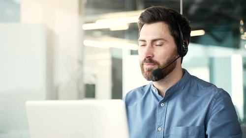 Corporate operator who works in customer support speaks on a video call using a laptop computer.