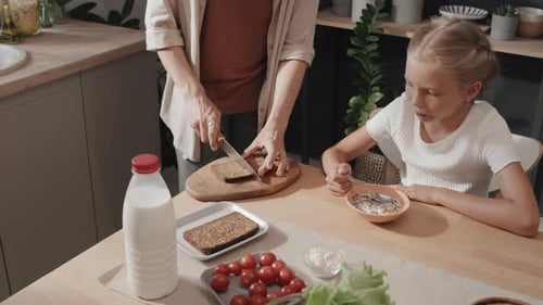 Mother and Child Having Breakfast in Sunny Kitchen