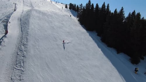Breathtaking Beauty of the Mountain in Winter and People Skiing on the Slope on an Overcast Day