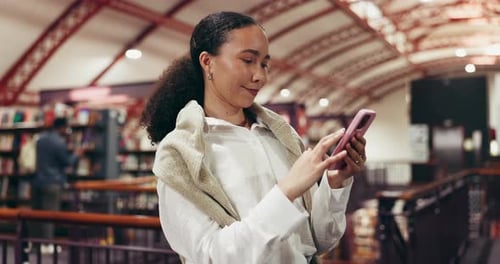 Phone, laughing and woman in library with typing for college email, chatting
