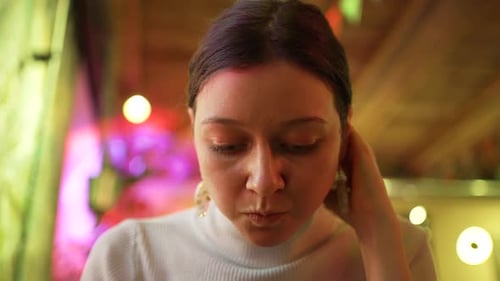 Woman Eats Salad and Enjoys Atmosphere Sitting in Cafe