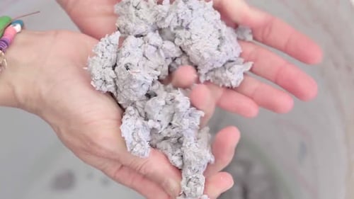 Hands touching wet paper for recycled handcraft