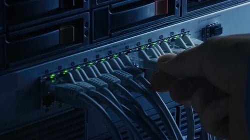 Technician Connecting Cables in Data Center Network