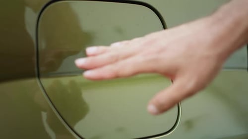 Extreme Close Up of Driver Opening Charging Port Flap Plugging Electric Car