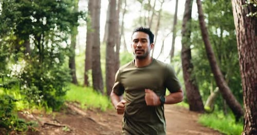 Outdoor, fitness and man running in forest in morning for workout, training or wellness in nature