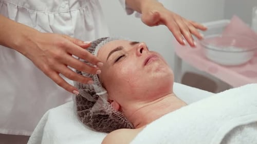 Cosmetologist Performing Procedure in Cosmetology Clinic on Patient Professional Therapist Applying