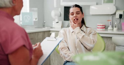 Woman Describing Dental Issues to a Healthcare Provider