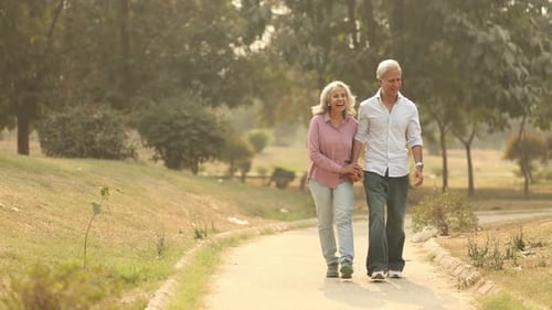 Happy Old Couple Enjoys A Peaceful Walk in the Park