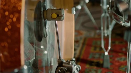 man's foot pressing bass drum pedal in recording studio drummer drumming indoors close-up