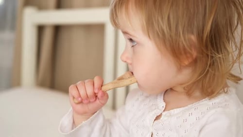 Toddler Playing with Toy in Bed