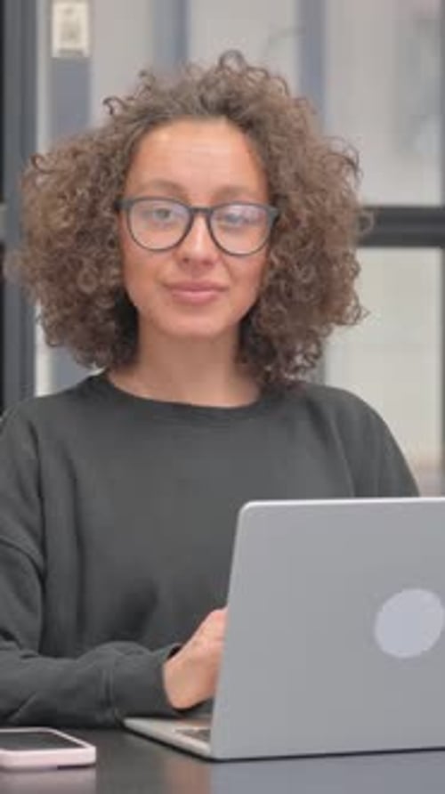 Woman works at computer in modern office