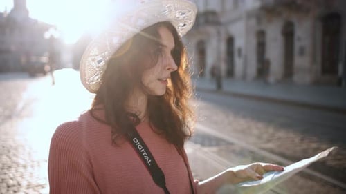 Young Woman Reading Map on City Street
