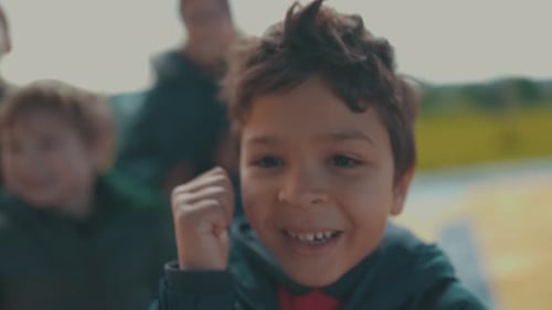 Group of Children Giving Thumbs Up in Urban Area
