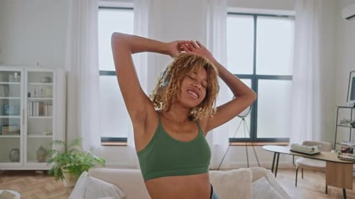 Cheerful Woman Dancing to Music at Home