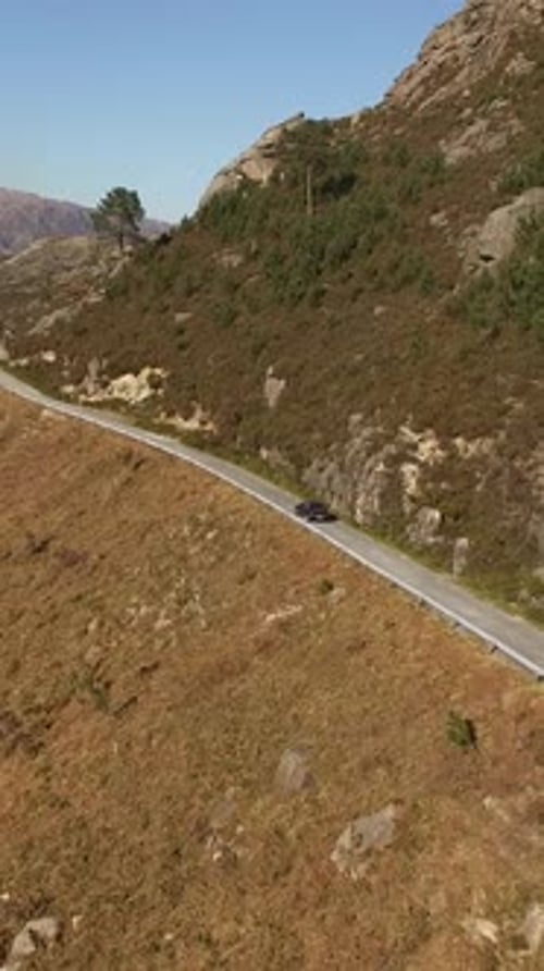 Vertical Video of car running in a mountain road