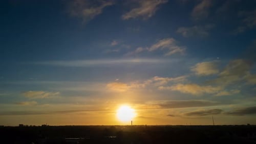 Timelapse of sunrise with clouds passing over suburban area