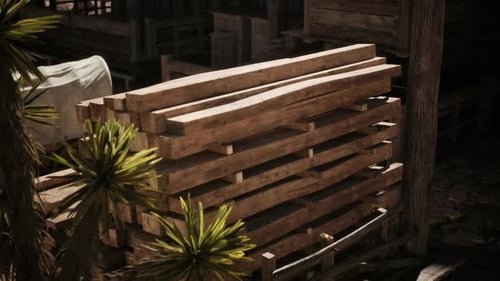 Wooden Pallets Stacked Near a Rustic Structure in a Sunlit Outdoor Area