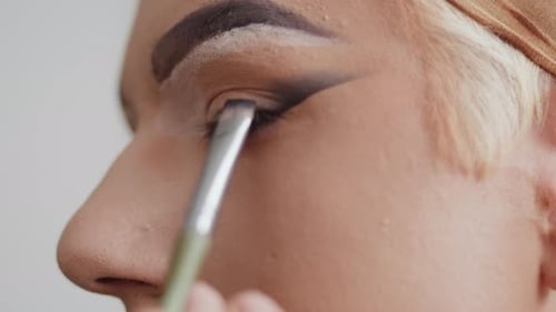 Close Up Applying Makeup to Eyelid with Brush