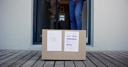 Man Picks Up Shipping Box from Front Porch